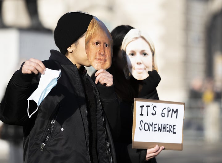 People gather to protest in Parliament Square in London