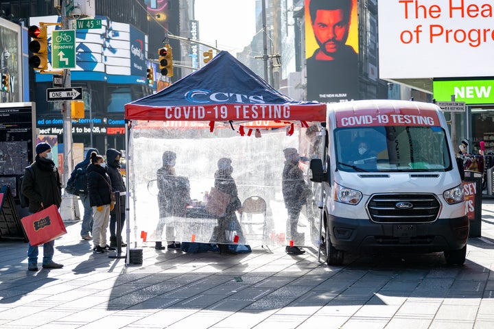 People stand in line in below-freezing temperatures to get COVID-19 tests during the surge in Times Square, New York City on January 11.