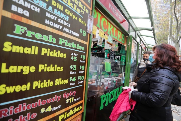 People buy food at a holiday market in New York, the United States, Dec. 7, 2021. U.S. annual inflation will remain above the Federal Reserve's target of 2 percent over the next three years amid rising wages and strong demand for goods and services, according to a survey released Monday by the National Association for Business Economics NABE.