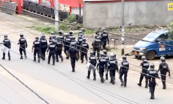A still image taken from a video shows riot police walk along a street in the English-speaking city of Buea, Cameroon October 1, 2017. via REUTERS TV