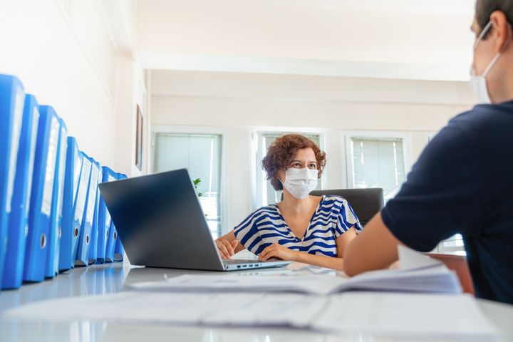 Executive women in medical masks interview