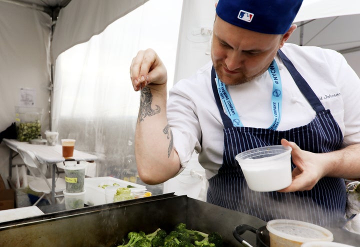 A chef at the 2018 Food and Wine festival in New York perfects his salting form.