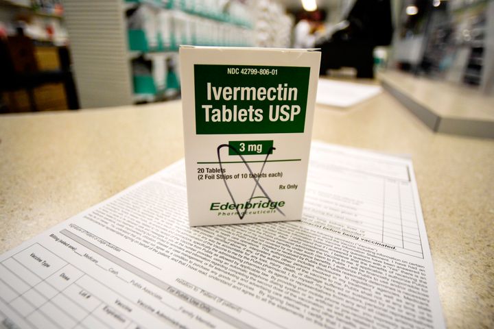 A box of ivermectin is shown in a pharmacy as pharmacists work in the background on Thursday, Sept. 9, 2021, in Georgia. (AP Photo/Mike Stewart)