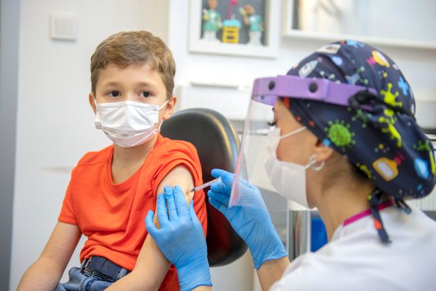 9-year-old boy getting a COVID-19 vaccine.