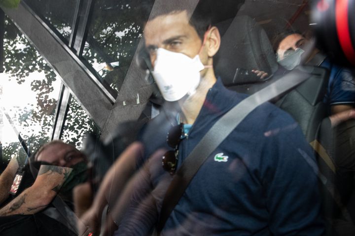 Serbian tennis player Novak Djokovic leaves the Park hotel on January 16, 2022 in Melbourne, Australia. Djokovic is in detention and faces deportation after his visa was cancelled by the Australian government. His appeal will be heard today, one day before he is scheduled to play in the Australian Open. (Photo by Diego Fedele/Getty Images)