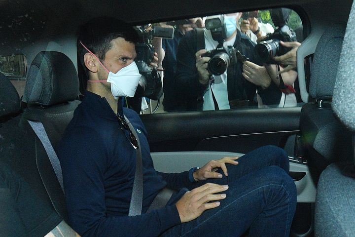 Serbian tennis player Novak Djokovic rides in car as he leaves a government detention facility before attending a court hearing at his lawyers office in Melbourne, Australia, Sunday, Jan. 16, 2022. (James Ross/AAP via AP)