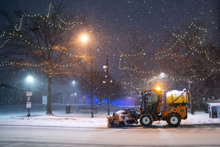 A snow plow clears Main Street in Greenville, South Carolina, Sunday.