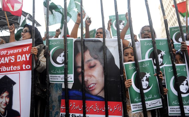 Pakistani protesters from the hard-line Sunni group Pasban hold portraits of Pakistani scientist Aafia Siddiqui during a demonstration marking International Women's Day on March 8, 2011. Siddiqui was sentenced to 86 years in jail by a U.S. court who found her guilty of the attempted murder of U.S. military officers in Afghanistan in 2008.
