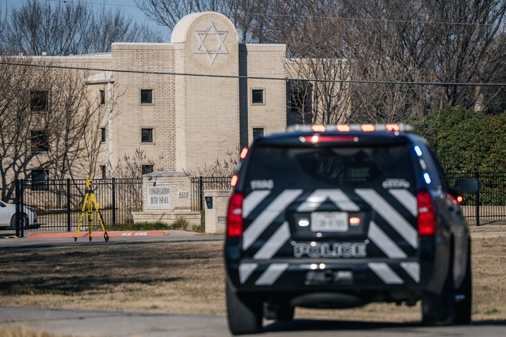 A law enforcement vehicle sits near the Congregation Beth Israel synagogue on Jan. 16 in Colleyville, Texas. The FBI identified the man who held members of the synagogue hostage over the weekend as a 44-year-old British national.