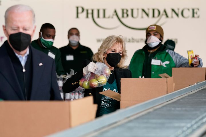 First lady Jill Biden packs produce as she and President Joe Biden volunteer at the hunger relief organization Philabundance in Philadelphia on Sunday.