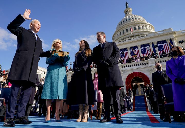 Joe Biden is seen being sworn in as the 46th president of the United States by Chief Justice John Roberts as Jill Biden holds the Bible on Jan. 20, 2021. Their children Ashley and Hunter watch.