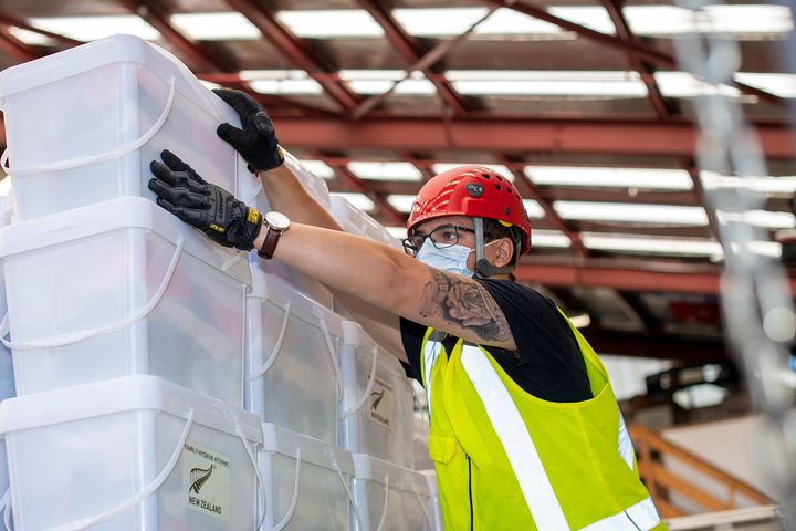 Air Movements personnel stack and secure pallets of disaster relief supplies to be sent to by Royal New Zealand Air Force C-130 to Tonga.