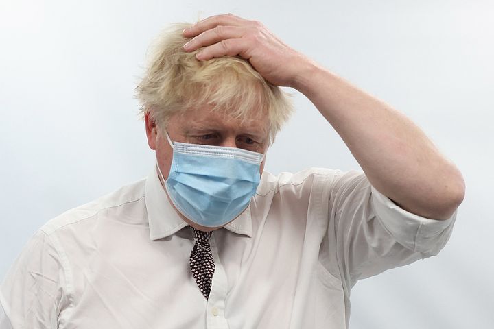 Boris Johnson gestures as he visits Finchley Memorial Hospital in North London on January 18, 2022.