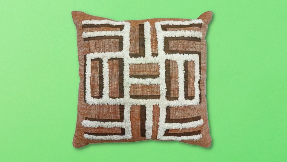 A pillow with an Adinkra symbol