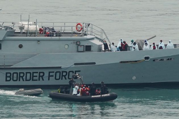 <strong>A group of people brought in to Dover, Kent, by Border Force officers.</strong>