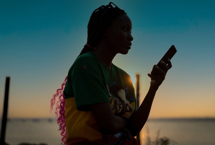 Girl on the beach using phone