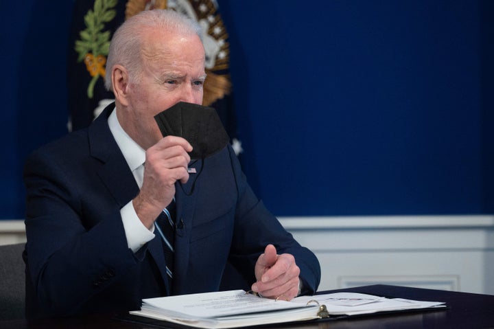 President Joe Biden holds up a KN95 mask as he delivers an update on his administration's whole-of-government COVID-19 surge response at the White House on Jan. 13, 2022. The White House announced plans to distribute a different type of mask, non-surgical N95 masks, from the Strategic National Stockpile.