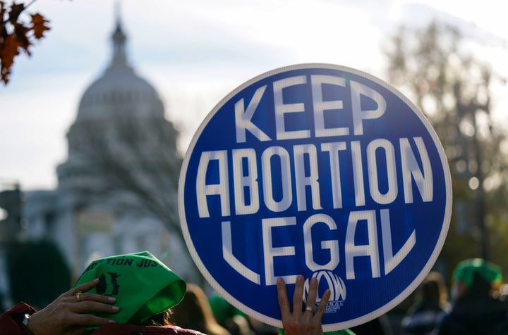 A participant holds a sign at the Women's March "Hold The Line For Abortion Justice" at the U.S. Supreme Court on December 01, 2021 in Washington, DC.