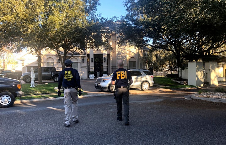 Federal agents search the home of U.S. Rep. Henry Cuellar in Laredo, Texas, on Jan. 19, 2022.