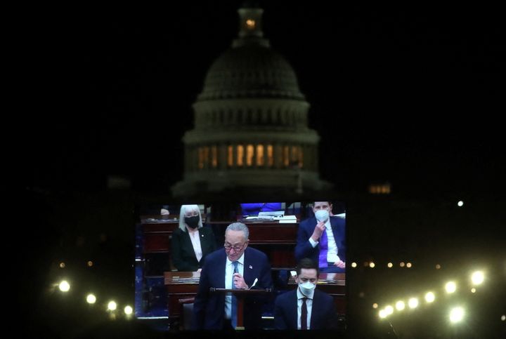 Senate Majority Leader Chuck Schumer (D-N.Y.) is projected live on a screen as he takes part in the debate from senators of voting rights legislation, on Jan. 19. 