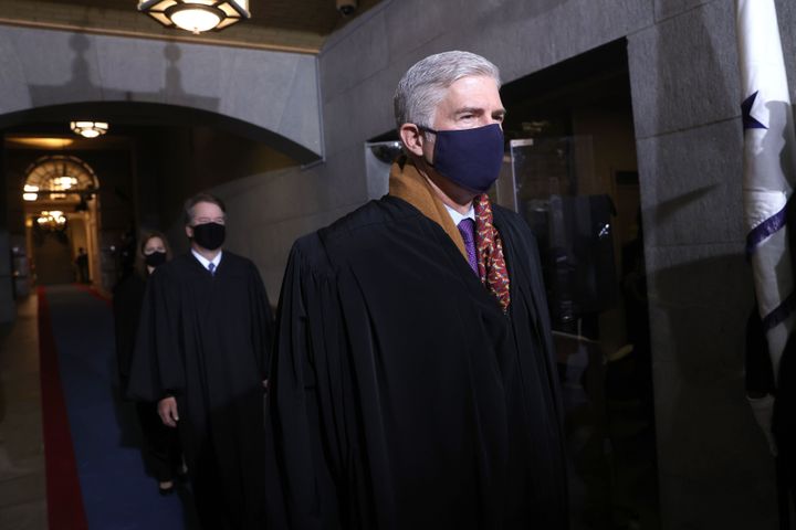 Justice Neil M. Gorsuch, seen here wearing a mask at President Joe Biden's inauguration, has been going without one at the Supreme Court lately — and leading the charge to block federal vaccine rules at the workplace.