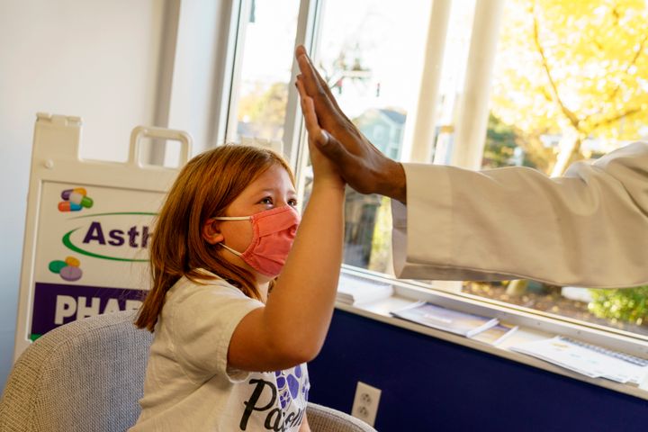 Hannah Beltram, 6, high-fives Dr. Eugenio Fernandez after she received the Pfizer COVID-19 vaccine for children in Providence, Rhode Island, on Nov. 5, 2021.