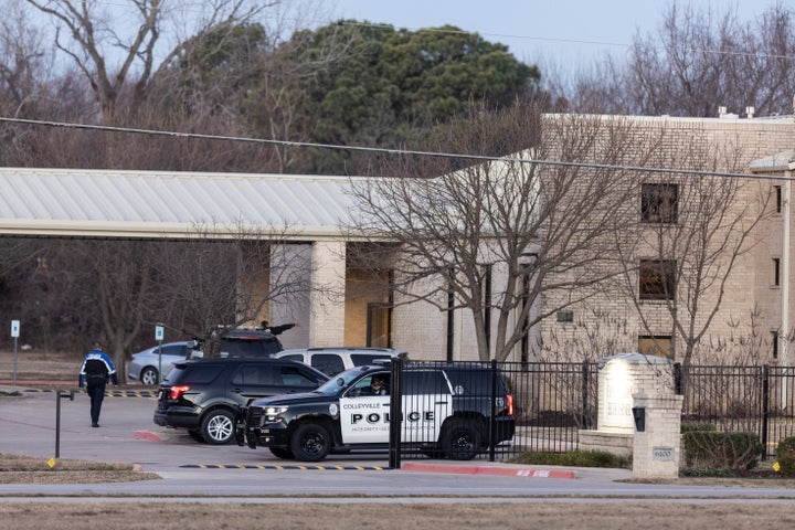 Police stand in front of the Congregation Beth Israel synagogue, Sunday, Jan. 16, 2022, in Colleyville, Texas. 