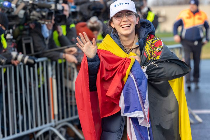 The youngest woman to fly solo around the world, 19-year-old Belgian-British pilot Zara Rutherford, wears the Flags of Belgium and the United Kingdom as she lands her ultralight Shark aircraft after five months circumnavigating the planet.