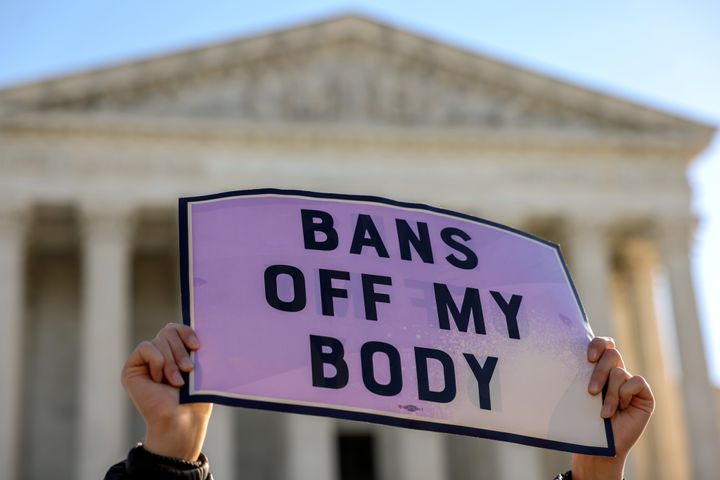 A pro-choice demonstrator holds a sign outside the U.S. Supreme Court on Nov. 1, 2021, as the justices hear arguments over a challenge to a Texas law that bans abortion after six weeks.