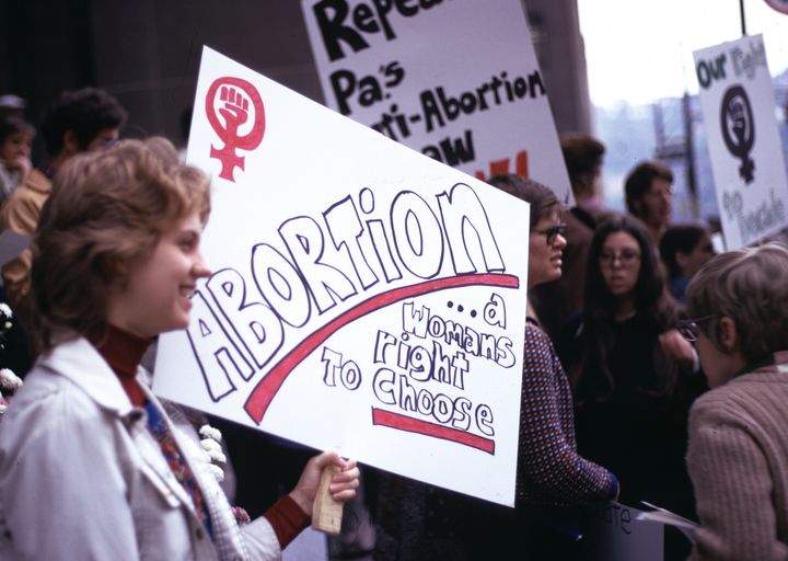 Woman holds sign at reproductive rights demonstration, Pittsburgh, PA, 1974.