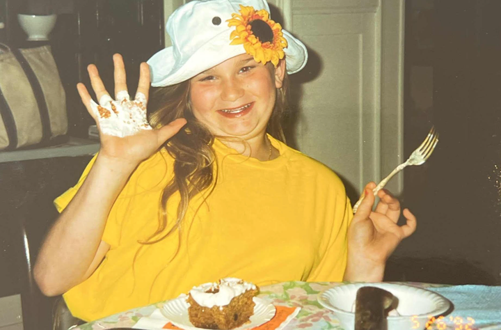 The author in 1992 at the age of 12 wearing clothes she'd gotten for her birthday and enjoying one of the rare moments of glee that only came in the presence of her family.