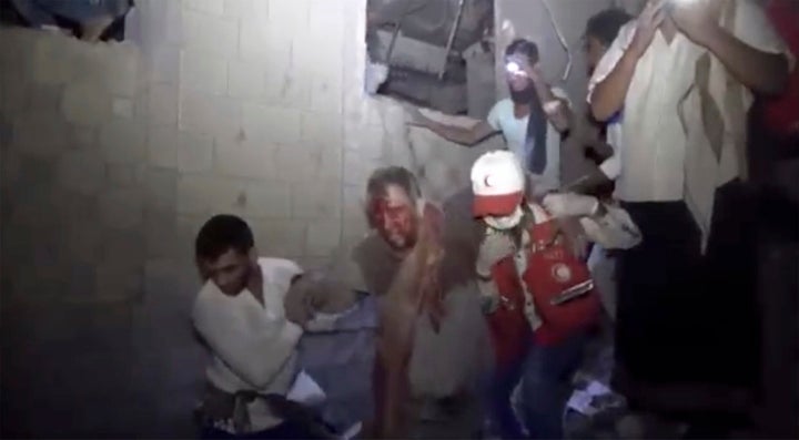 A man is rescued early Friday, Jan. 21, 2022, after Saudi-led airstrikes targeted a site in the city of Hodeida, Yemen, in a photo provided by Ansar Allah Media Office. (Ansar Allah Media Office via AP)
