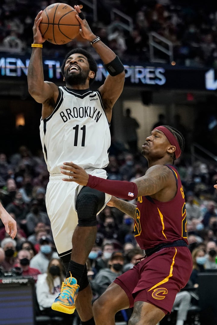 Brooklyn Nets' Kyrie Irving drives against Cleveland Cavaliers' Brandon Goodwin on Monday, Jan. 17, 2022, in Cleveland.