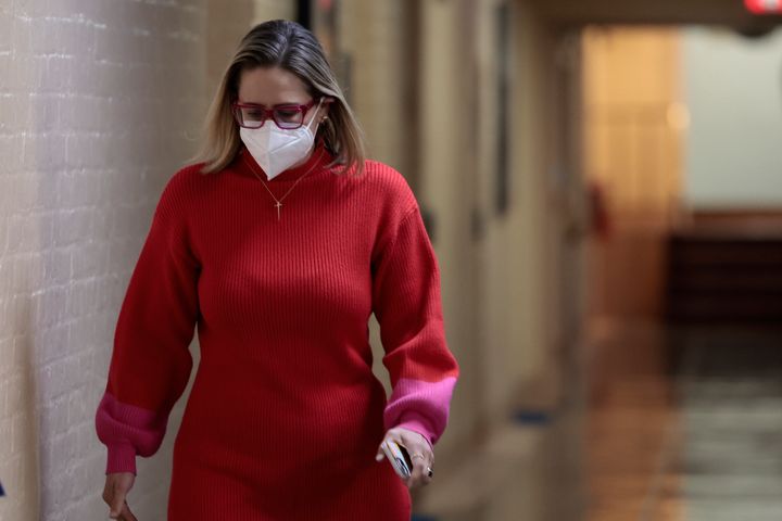 : Sen. Kyrsten Sinema (D-AZ) walks to her office in the basement of the U.S. Capitol Building on January 19, 2022 in Washington, DC.