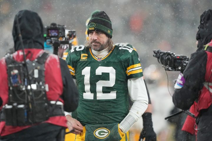 A dejected Aaron Rodgers walks off the field after the Packers lost to the 49ers in a playoff game on Saturday.