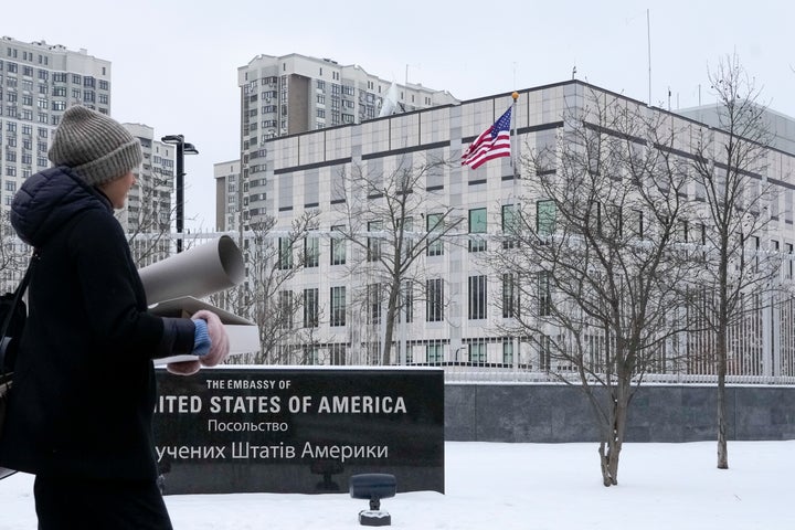 A woman walks past the U.S. Embassy in Kyiv, Ukraine, Monday, Jan. 24, 2022. The State Department is ordering the families of all American personnel at the U.S. Embassy in Kyiv to leave the country and allowing non-essential staff to leave Ukraine. The move comes amid heightened fears of a Russian invasion of Ukraine despite talks between U.S. and Russian officials. (AP Photo/Efrem Lukatsky)