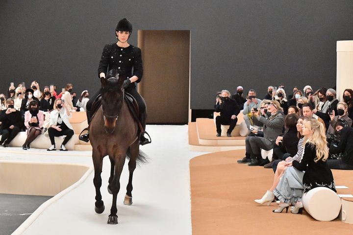 Sofia Coppola looks on as Charlotte and her horse make their way down the runway. 