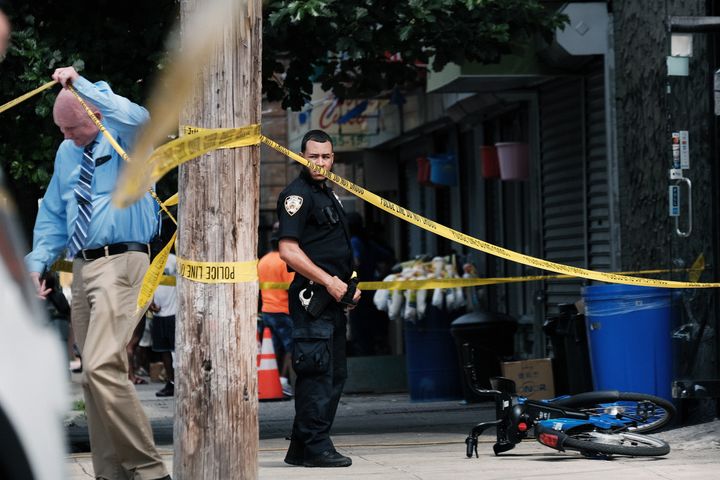 Police converge on the scene of a shooting in Brooklyn, one of numerous during the day, on July 14, 2021, in New York City.
