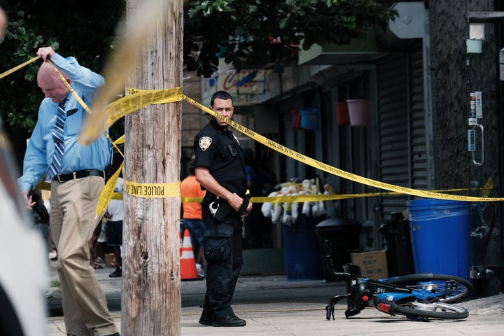 Police are gathering at the scene of a shooting in Brooklyn, one of numerous during the day, July 14, 2021, in New York City.
