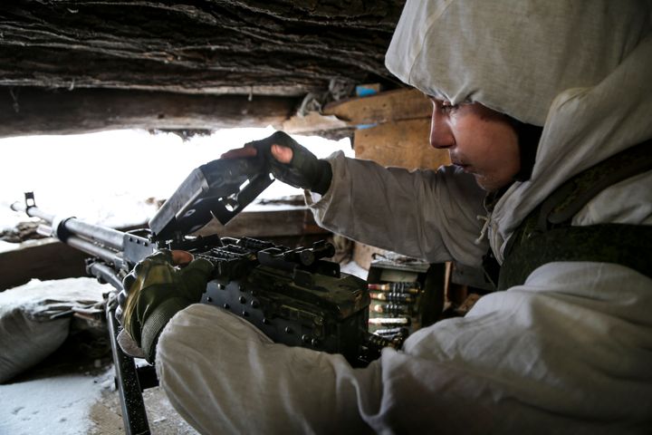 A serviceman checks his machine-gun in a shelter on the territory controlled by pro-Russian militants at frontline with Ukrainian government forces in Slavyanoserbsk, Luhansk region, eastern Ukraine, Tuesday, Jan. 25, 2022. (AP Photo/Alexei Alexandrov)
