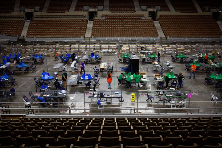 Contractors working for Cyber Ninjas examine and recount ballots from the 2020 general election on May 3, 2021, in Phoenix, Arizona.