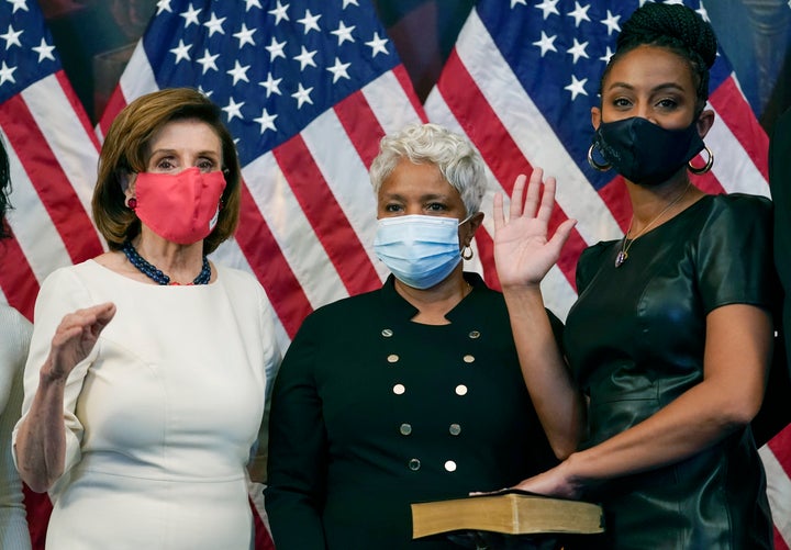 Rep. Shontel Brown (D-Ohio), right, and her mother, Rikki, pose with House Speaker Nancy Pelosi (D-Calif.), left, during a ceremonial swearing-in in November.