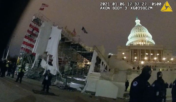 After Jeffrey Smith was hit by a metal object hurled by a member of the pro-Trump mob, a still from his body camera footage shows the inauguration platform outside the Capitol in tatters.