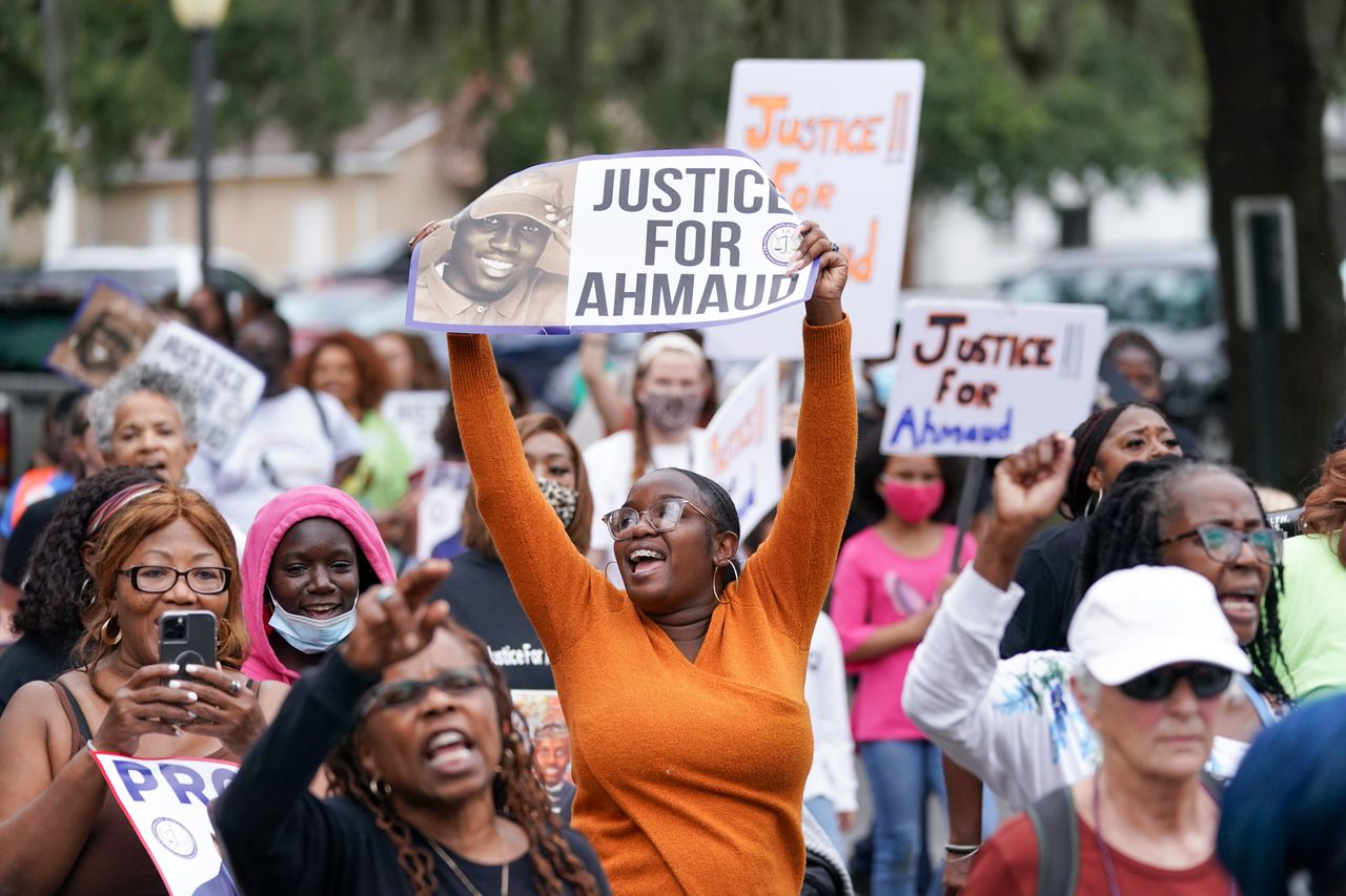 Demonstrators march near the Glynn County Courthouse after the adjournment of daily court proceedings in the trial for the killers of Ahmaud Arbery on Nov. 18, 2021, in Brunswick, Georgia.