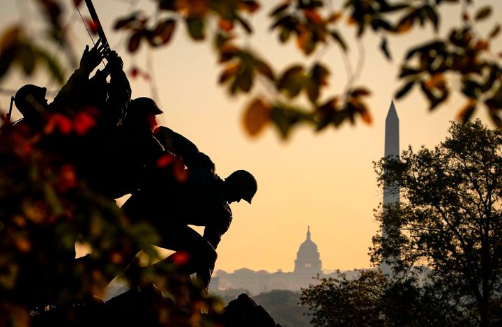 The U.S. Marine Corps' Iwo Jima Memorial can be seen as the morning sun begins to rise behind the U.S. Capitol and Washington Monument on Nov. 7, 2020, in Arlington, Virginia.