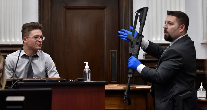 Dominick Black, left, identifies the rifle Kyle Rittenhouse used on Aug. 25, 2020, during Rittenhouse's trial at the Kenosha County Courthouse in Kenosha, Wisconsin, on Nov. 2, 2021. Black, who bought an AR-15-style rifle for Kyle Rittenhouse, has pleaded no contest to a reduced charge of contributing to the delinquency of a minor in a deal with prosecutors to avoid prison. A Wisconsin judge accepted Dominick Black's plea on Monday, Jan. 10, 2022. (Sean Krajacic/The Kenosha News via AP, Pool File)