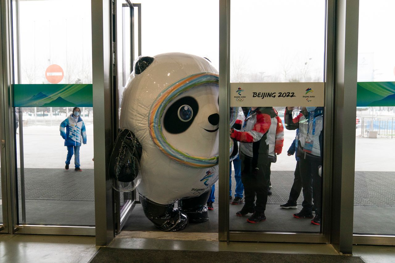 Bing Dwen Dwen, an inflated mascot of the 2022 Winter Olympics, tries to squeeze through the door of the main media center at at the games on Monday. 