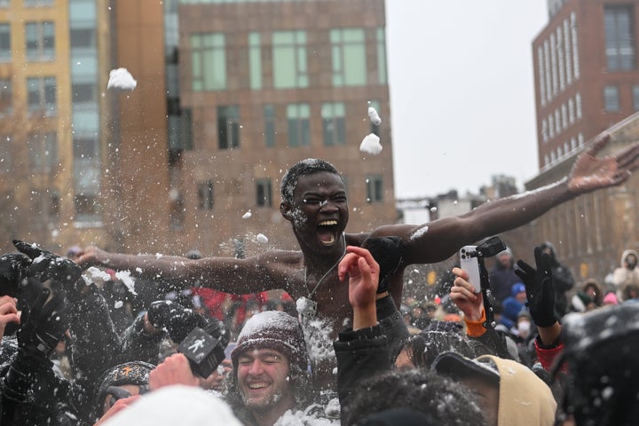 Chippi, 22, from Senegal sits on someone’s shoulder shirtless participating in a large snow ball fight in Washington Square Park in New York City.