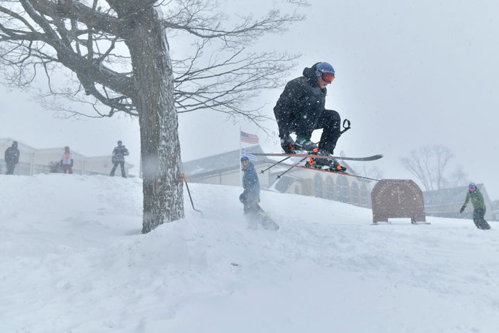 Zack Andersen of Somerville skis off a jump built on the lawn of Dormition of the Virgin Mary Greek Orthodox Church, Saturday, Jan. 29, 2022, in Somervillle, Mass. (AP Photo/Josh Reynolds)