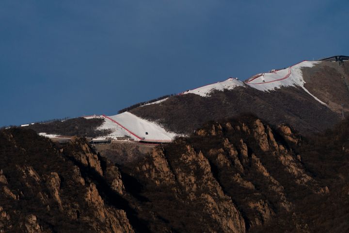 A ski slope at the Beijing Winter Olympics runs on a nearly snowless mountains on Jan. 28.